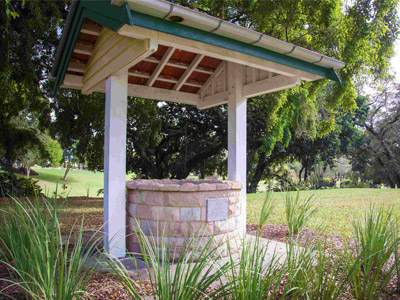 Historic-style stone Wishing Well in the landscaped gardens of Queen’s Park