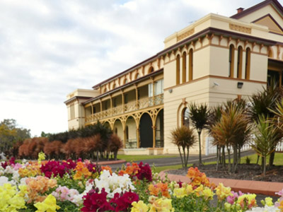 Maryborough Courthouse framed by colourful garden beds and heritage landscaping.