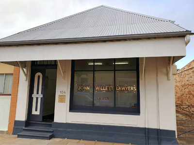 Historic commercial building housing John Willett Lawyers, featuring original 19th‑century shopfront architecture